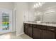 Modern bathroom with double vanity, granite countertops, and pool access at 4141 Lana Ave, Davenport, FL 33897