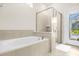 Modern bathroom with soaking tub, glass shower, and tile accents at 4141 Lana Ave, Davenport, FL 33897