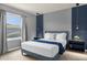 Blue themed bedroom with a queen bed and natural light at 4141 Lana Ave, Davenport, FL 33897