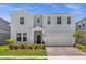 Charming two-story home with a welcoming front entrance and landscaped yard at 4141 Lana Ave, Davenport, FL 33897
