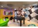 Game room featuring Super Mario wall art, foosball, and gaming chairs at 4141 Lana Ave, Davenport, FL 33897