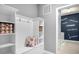 Laundry room with built-in shelving, bench seating, and a stylish accent wall at 4141 Lana Ave, Davenport, FL 33897