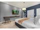 Main bedroom with a king-size bed, ensuite bathroom, and mounted TV at 4141 Lana Ave, Davenport, FL 33897