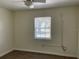 Cozy bedroom featuring wood-look floors and a window with blinds at 4423 Reaves Rd, Kissimmee, FL 34746