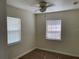 Well-lit bedroom with wood-look floors and window blinds at 4423 Reaves Rd, Kissimmee, FL 34746