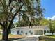 Newly painted one-story home with carport and landscaped yard at 4423 Reaves Rd, Kissimmee, FL 34746