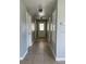 Bright hallway with light colored walls and tile flooring at 4423 Reaves Rd, Kissimmee, FL 34746