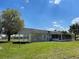 Rear view of the house with covered patio and screened enclosure at 4423 Reaves Rd, Kissimmee, FL 34746
