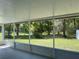 Screened porch overlooking a spacious backyard with mature trees at 4423 Reaves Rd, Kissimmee, FL 34746