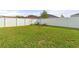 Large backyard with lush green grass and a white vinyl fence at 4642 Calumet Dr, Saint Cloud, FL 34772