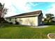 Side view of tan house with well-maintained landscaping at 504 Ridge View Dr, Davenport, FL 33837