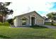 Tan one-story house with a two-car garage and landscaped yard at 504 Ridge View Dr, Davenport, FL 33837