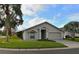 Tan house with palm trees, two-car garage, and landscaped lawn at 504 Ridge View Dr, Davenport, FL 33837