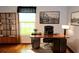 Home office with hardwood floors, built-in shelving, and a large desk at 504 Ridge View Dr, Davenport, FL 33837