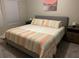 King bedroom with striped bedding and window at 5107 Killarney Way, Kissimmee, FL 34746