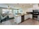 Open concept kitchen with island, stainless steel appliances, and granite countertops at 5107 Killarney Way, Kissimmee, FL 34746