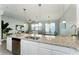 Open kitchen with granite island, stainless steel appliances, and view to living room at 5107 Killarney Way, Kissimmee, FL 34746