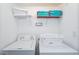 Laundry room with washer, dryer, and shelving for storage at 5107 Killarney Way, Kissimmee, FL 34746