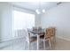 Dining area features a modern table with chairs and large window at 527 Noble Ave, Davenport, FL 33837