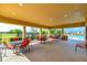 Relaxing pool area with covered seating and tables at 527 Noble Ave, Davenport, FL 33837