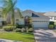 Single-story house featuring a two-car garage and lush landscaping at 543 Birkdale St, Davenport, FL 33897