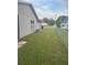 Side yard with chain link fence at 606 Wallaby Ln, Kissimmee, FL 34759