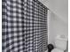 Bathroom with black and white checkered shower curtain at 608 Gila Dr, Kissimmee, FL 34759