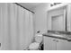 Bathroom with white shower curtain and granite vanity at 608 Gila Dr, Kissimmee, FL 34759