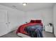 Bedroom with white doors and a red comforter at 608 Gila Dr, Kissimmee, FL 34759