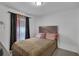Bedroom with mauve comforter and dark curtains at 608 Gila Dr, Kissimmee, FL 34759