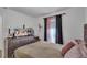 Bedroom with TV and mauve bedding at 608 Gila Dr, Kissimmee, FL 34759