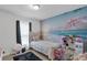 Bedroom with beach mural and twin bed at 608 Gila Dr, Kissimmee, FL 34759