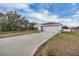 House exterior with driveway and landscaping at 608 Gila Dr, Kissimmee, FL 34759