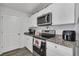 Kitchen with granite countertops and stainless steel appliances at 608 Gila Dr, Kissimmee, FL 34759
