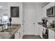 White kitchen with granite countertops and stainless steel appliances at 608 Gila Dr, Kissimmee, FL 34759