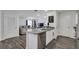 Kitchen island with granite countertop and stainless steel dishwasher at 608 Gila Dr, Kissimmee, FL 34759