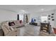 Spacious living room with gray sectional sofa and wood-look floors at 608 Gila Dr, Kissimmee, FL 34759