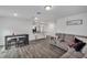 Open living space with gray sectional and kitchen view at 608 Gila Dr, Kissimmee, FL 34759