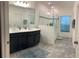 Double vanity bathroom with a large walk-in shower and tile flooring at 723 Benjamin Trl, Davenport, FL 33837