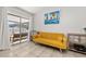 Comfortable living area with yellow couch and sliding doors to patio at 7710 Indian Ridge S Trl, Kissimmee, FL 34747