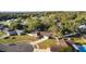 Aerial view of a house with a pool in a quiet residential neighborhood at 8438 Bay Oak Ct, Orlando, FL 32810