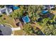 An aerial view showcasing a house with a large backyard and a pool at 8438 Bay Oak Ct, Orlando, FL 32810