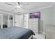Bedroom with dresser, TV, and sliding mirrored closet at 8438 Bay Oak Ct, Orlando, FL 32810