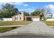 House exterior showcasing a stone fireplace and a landscaped yard at 8438 Bay Oak Ct, Orlando, FL 32810