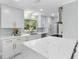 Modern kitchen with white cabinets, marble counters, and gold accents at 8438 Bay Oak Ct, Orlando, FL 32810