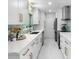 White kitchen with marble countertops and gold hardware at 8438 Bay Oak Ct, Orlando, FL 32810