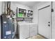 Laundry room with washer, dryer, and extra storage at 8438 Bay Oak Ct, Orlando, FL 32810