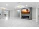 Open living area with marble floors, fireplace, and large TV at 8438 Bay Oak Ct, Orlando, FL 32810