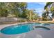 Large kidney shaped pool with a spa at 8438 Bay Oak Ct, Orlando, FL 32810