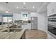 Bright kitchen featuring a farmhouse sink and stainless steel appliances at 8549 Hillcrest Dr, Groveland, FL 34736